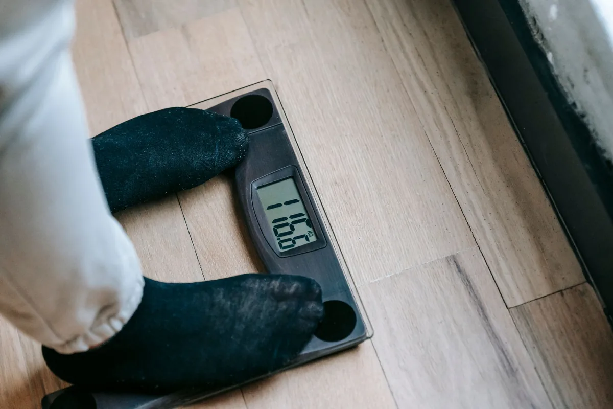 A person standing on digital bathroom scales